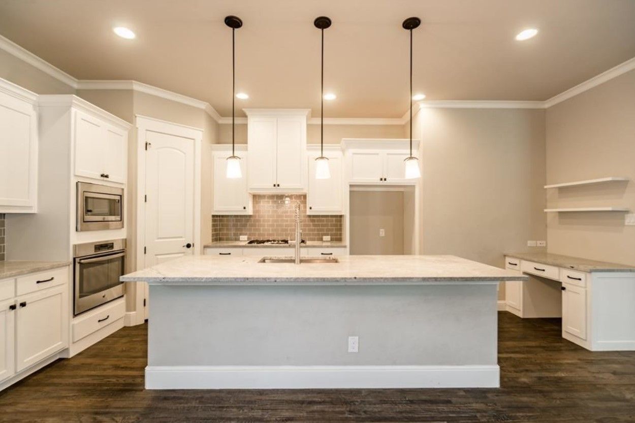 Kitchen with granite island and pendant lights